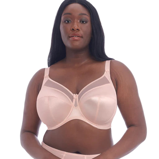 Woman wearing a beige bra on a white background
