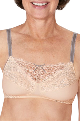 Beige lace bra worn by a person on a white background