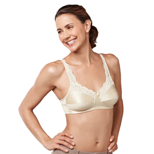 Woman wearing a beige bra against a plain background
