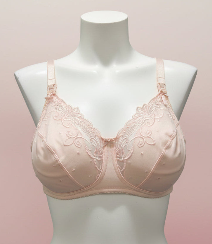 Pink bra with lace details on a mannequin bust