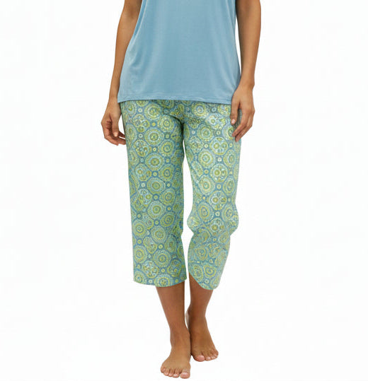 Light blue top and green patterned PAJAMA pants on a mannequin against a white background