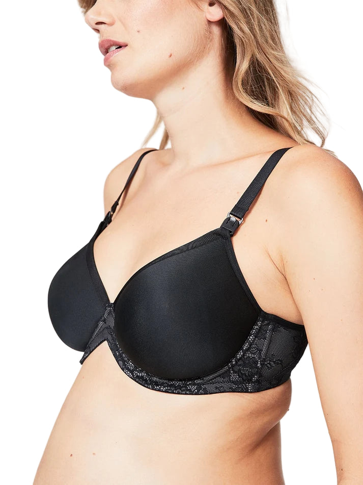 Woman wearing a black bra with lace details on a plain background