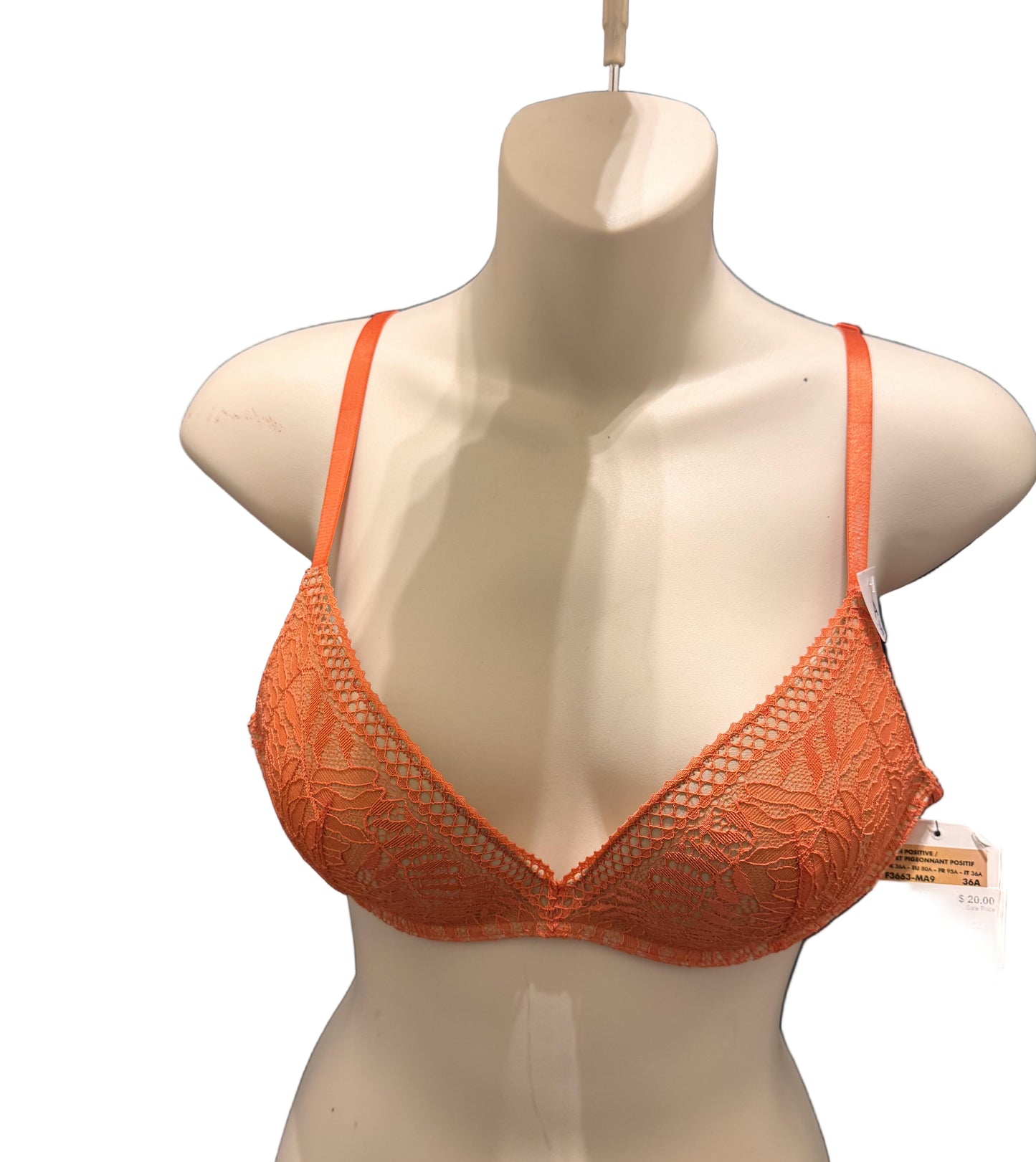 Orange bra on a mannequin against a blue textured background