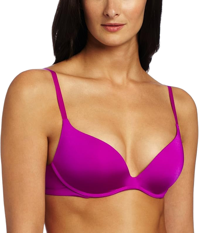Woman wearing a bright pink bra against a white background