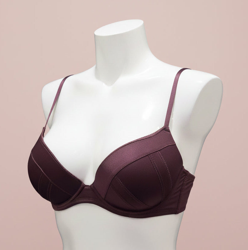Mannequin wearing a maroon bra on a blue background