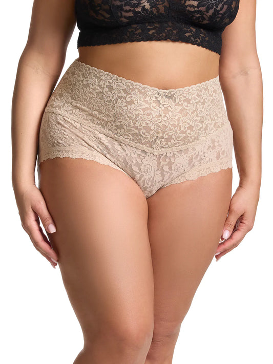 Beige lace underwear worn by a person on a white background