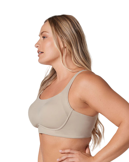 Woman wearing a beige sports bra against a plain background