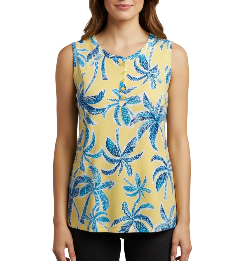 Yellow shirt with blue palm tree pattern on a beige surface