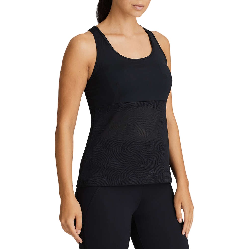 Person wearing a black tank top and leggings on a white background