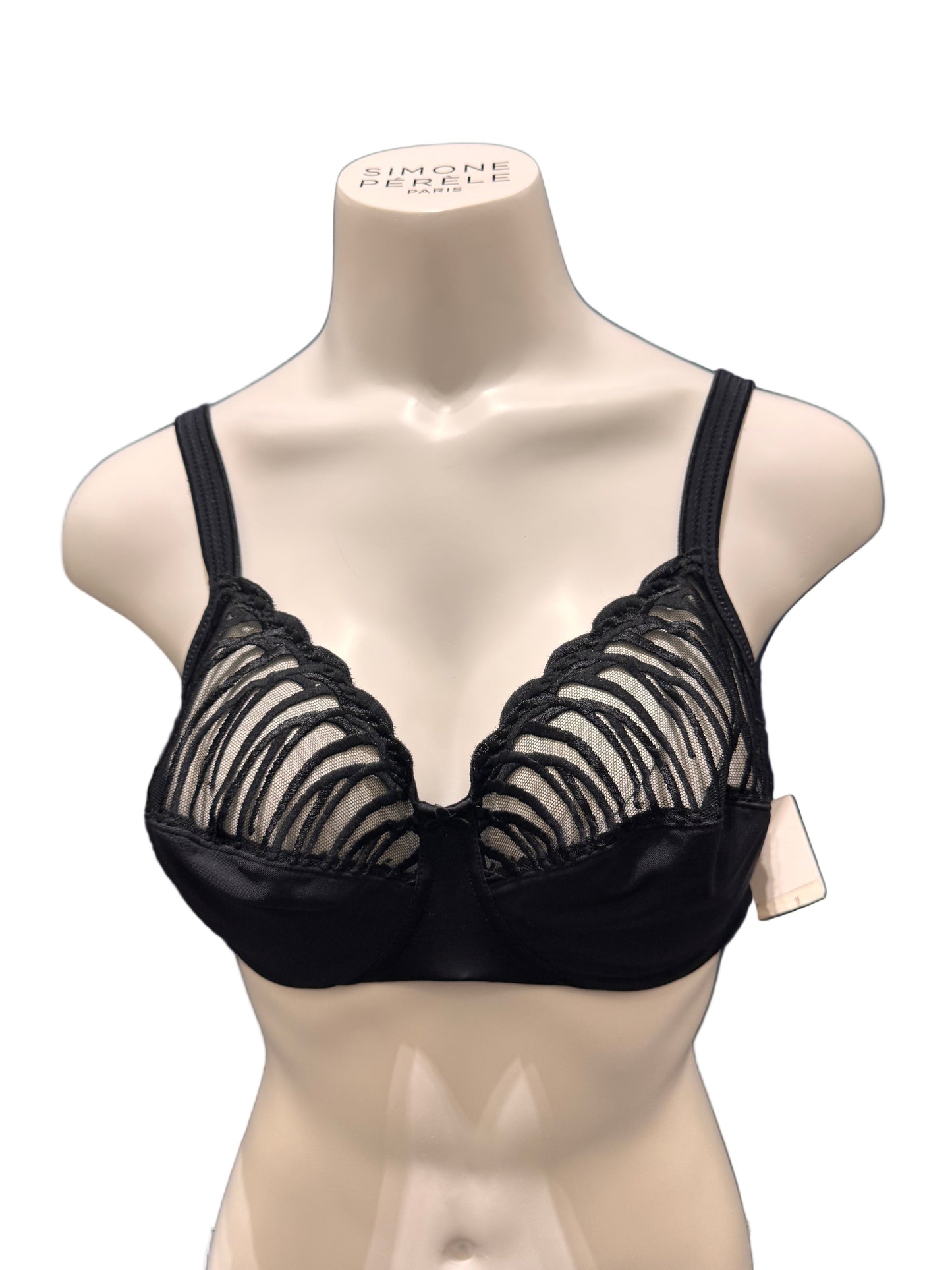 Black lace lingerie on a mannequin against a dark blue background