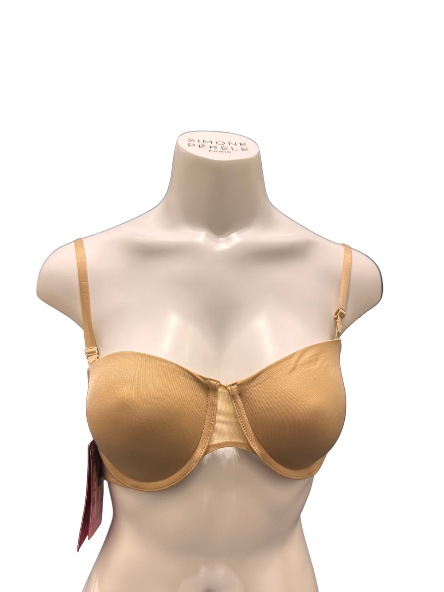 Mannequin bust wearing a beige bra on a dark blue fabric background