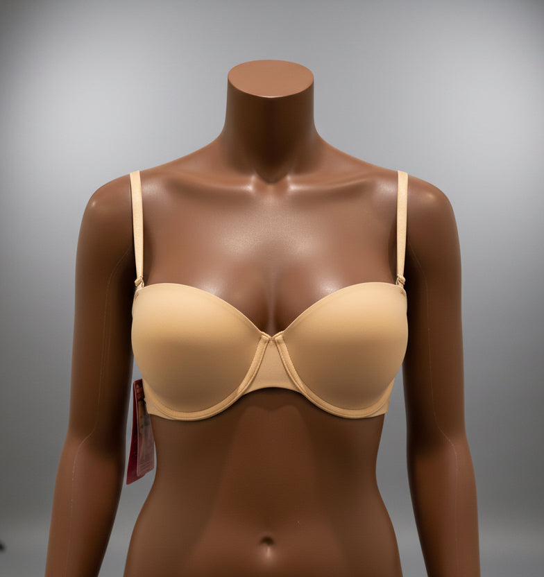 Mannequin bust wearing a beige bra on a dark blue fabric background