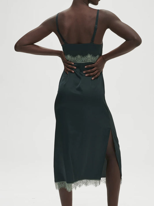 Dark green dress with lace details on a white background