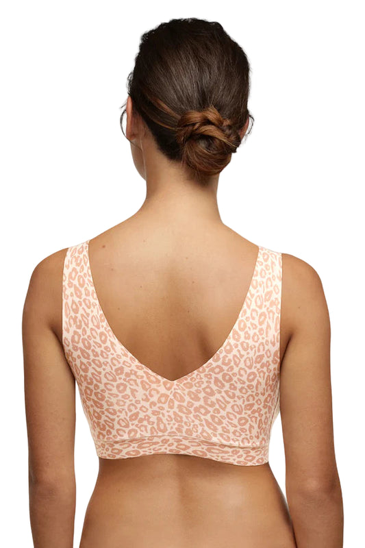 Woman wearing a leopard print BRA on a white background