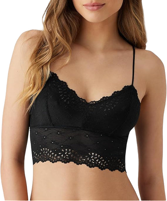 Woman wearing a black lace bralette on a white background