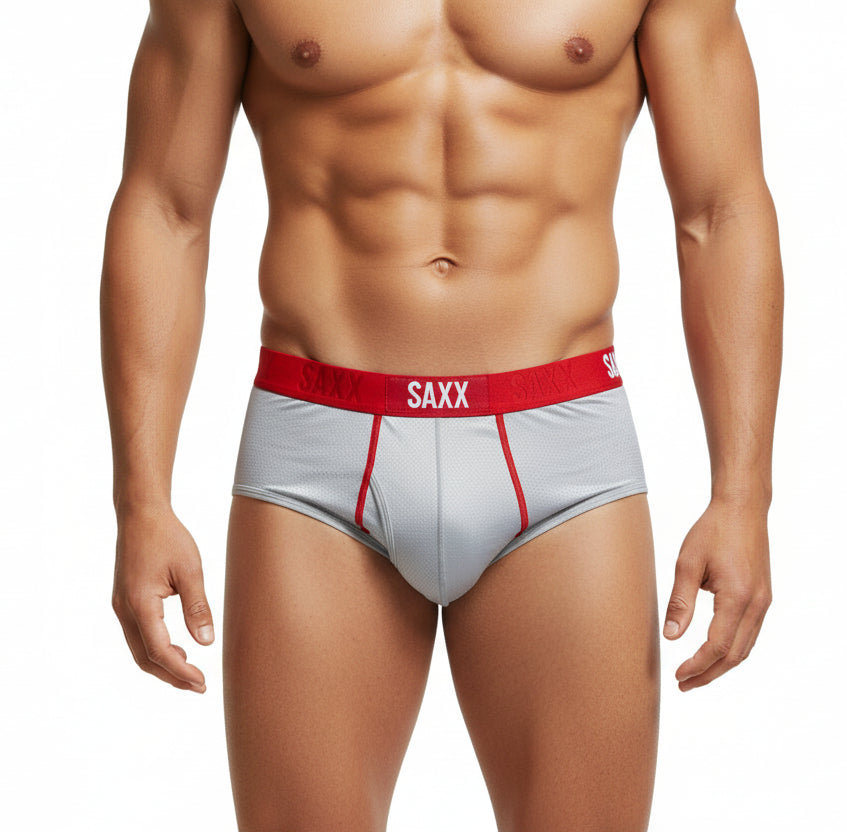Gray underwear with red waistband and 'SAXX' branding on a white background
