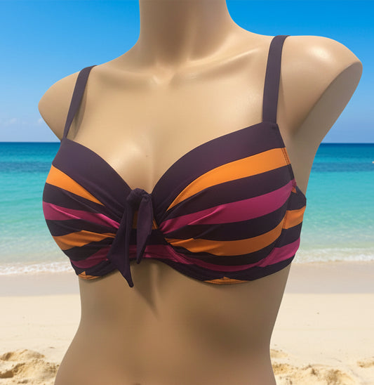 A bikini top in plum purple, tangerine orange, and punch pink with a bow detail in the front and ruching detail across cups, displayed on a mannequin.