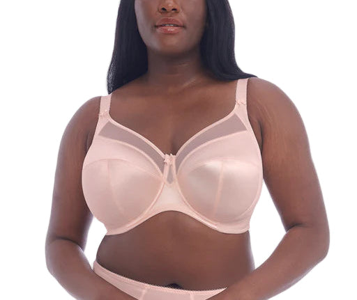 Woman wearing a beige bra on a white background