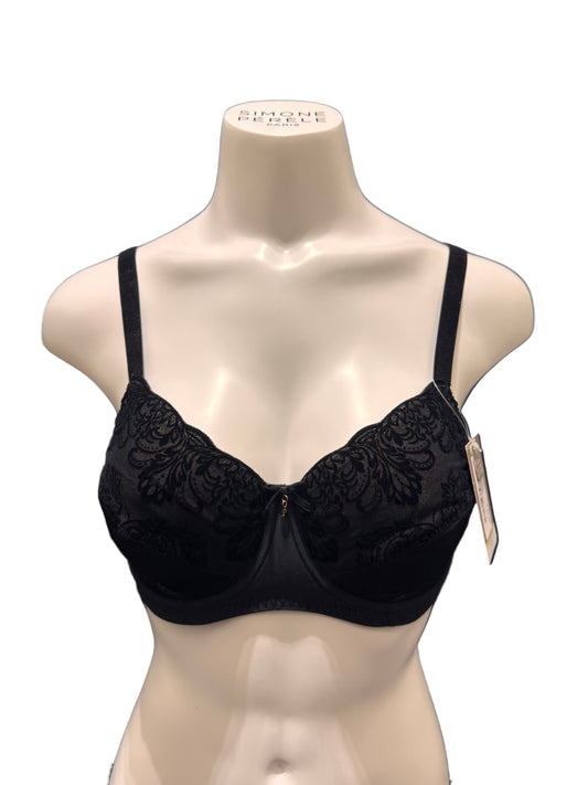 Black lace bra on a mannequin against a dark blue background