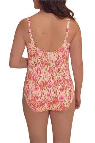 Woman wearing a colorful patterned swimsuit on a beige background