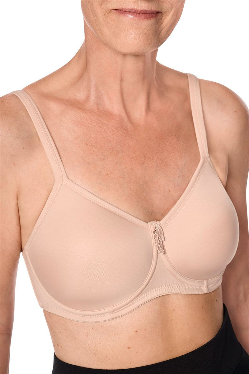 Woman wearing a beige bra against a white background