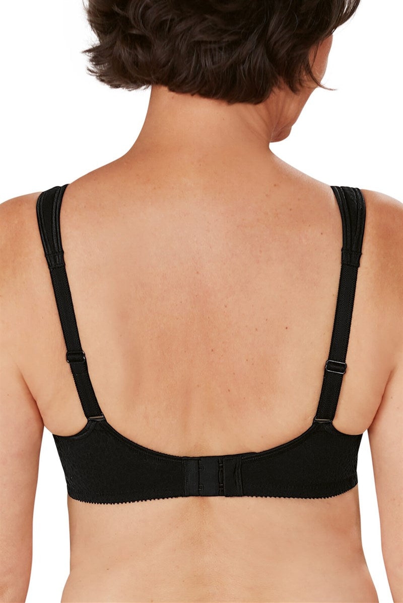 Black bra worn by a person on a white background