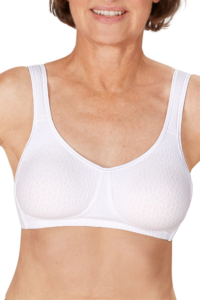 Woman wearing a white bra against a plain background