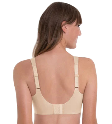 Woman wearing a beige compression garment on a white background