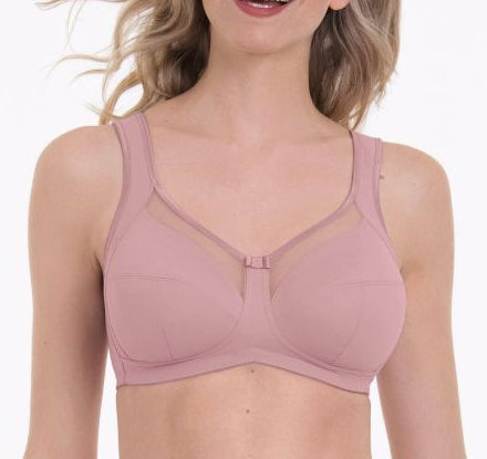 Woman wearing a pink bra on a white background