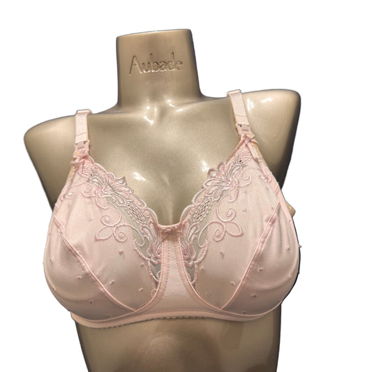 Pink bra with lace details on a mannequin bust 