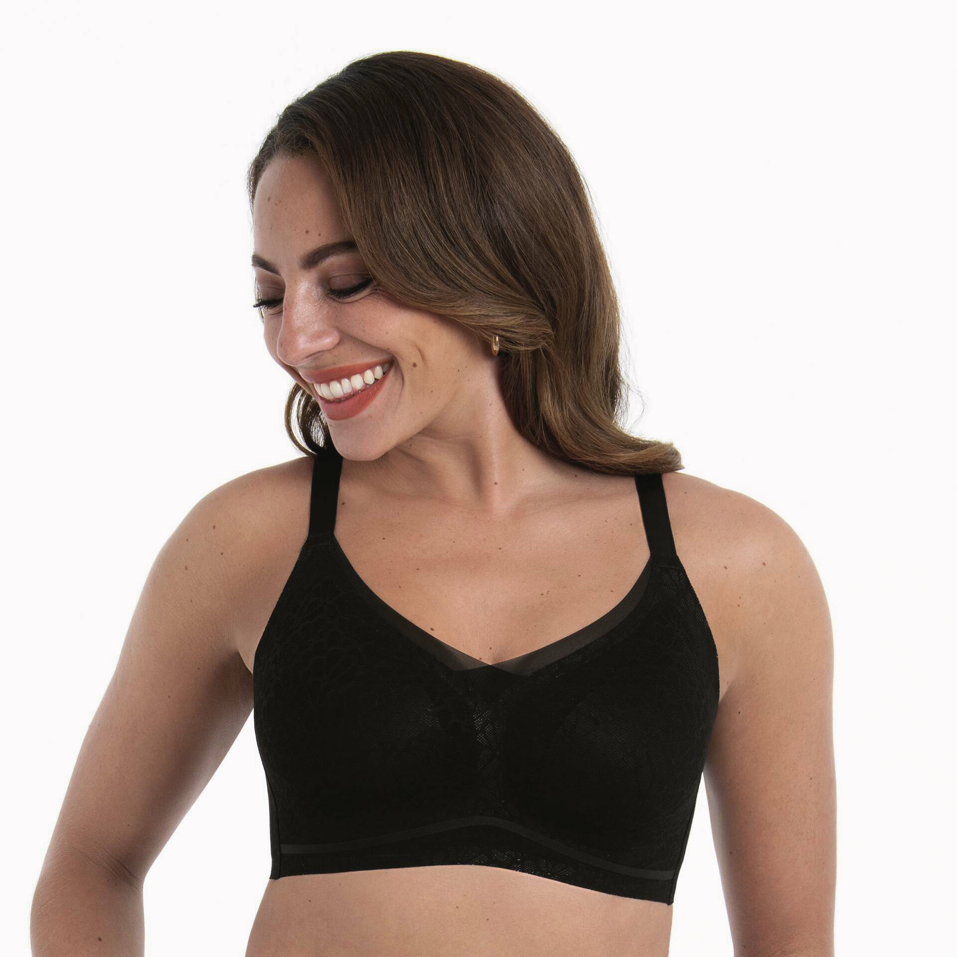 Woman wearing a black bralette on a white background