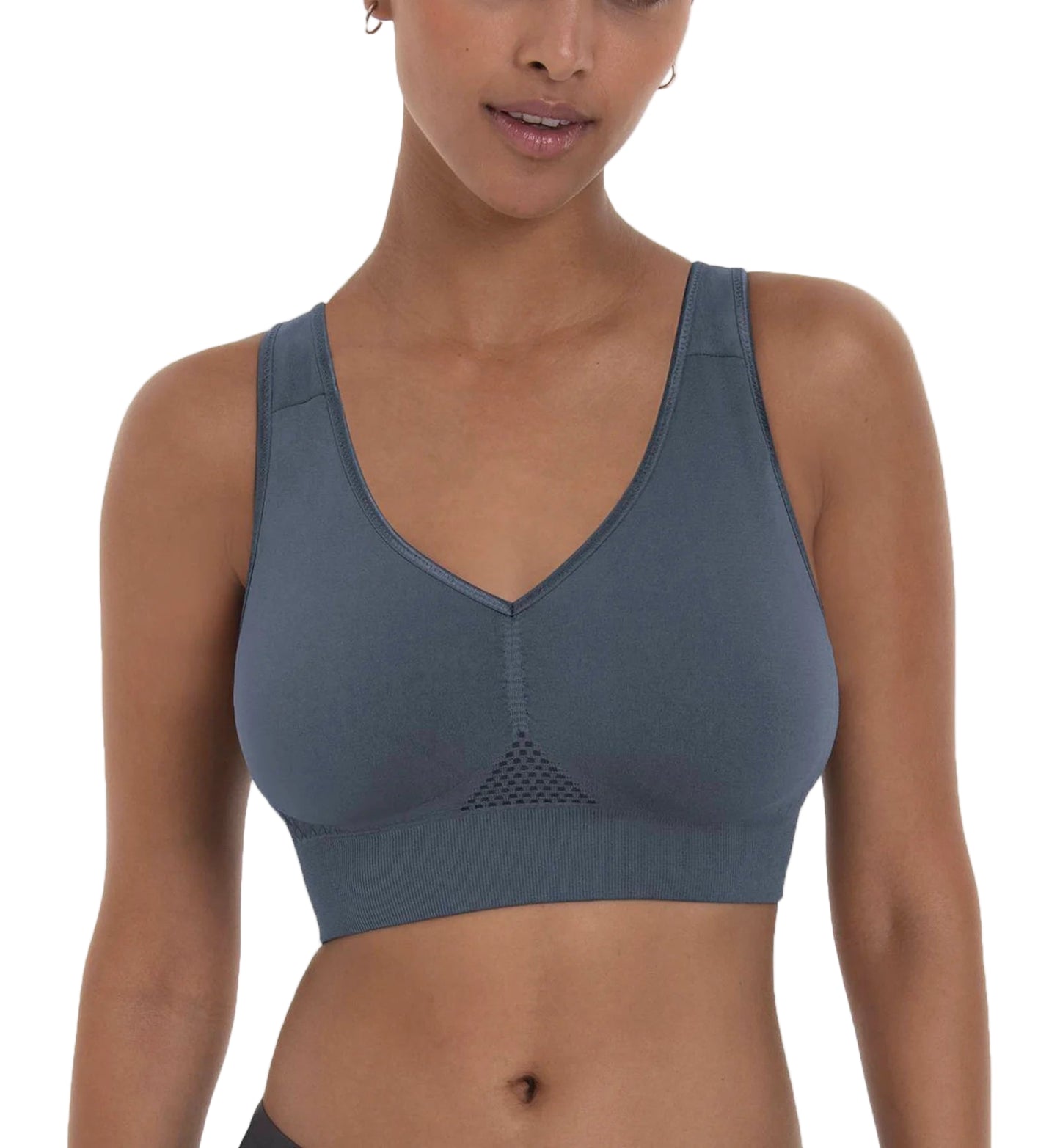 Woman wearing a gray sports bra on a white background