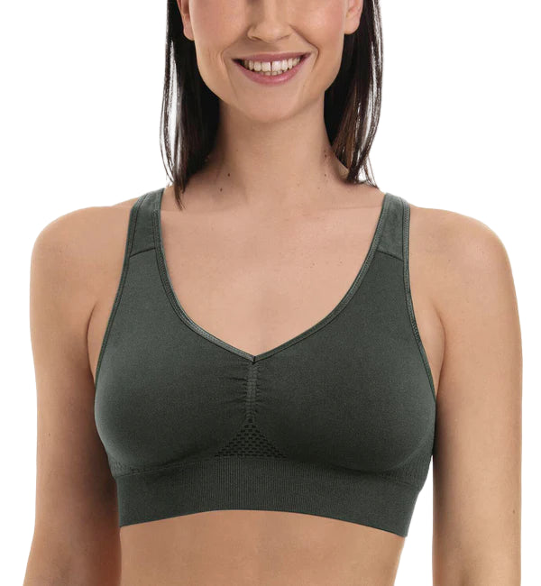 Woman wearing a green sports bra on a white background