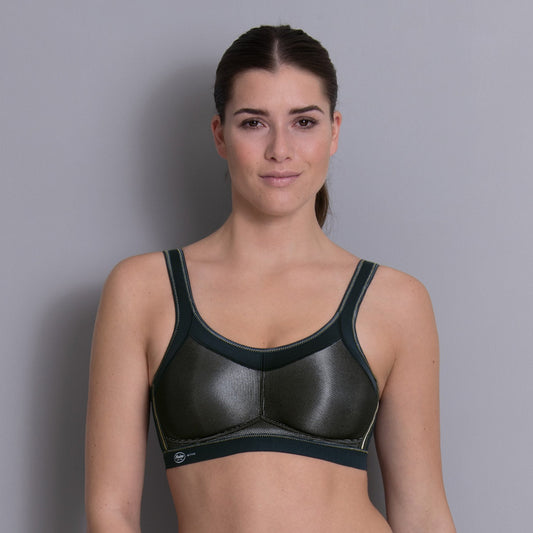 Woman wearing a black sports bra against a gray background