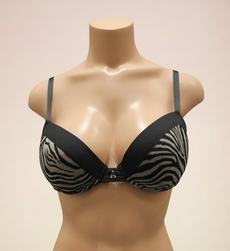 Black and zebra print bra on a mannequin against a dark background
