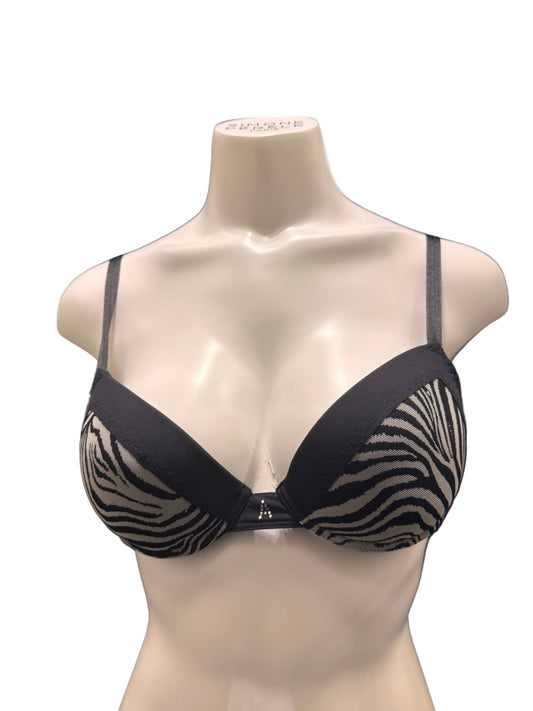 Black and zebra print bra on a mannequin against a dark background