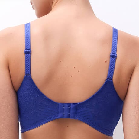 Blue bra worn by a person on a white background