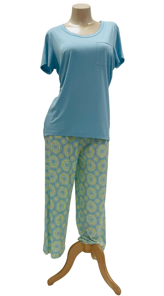 Light blue top and green patterned PAJAMA pants on a mannequin against a white background