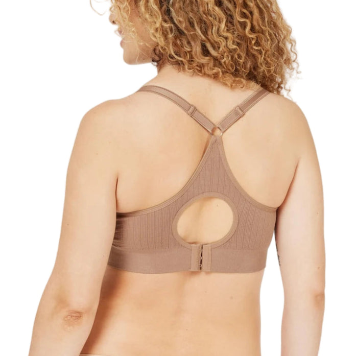 Woman wearing a brown sports bra on a white background