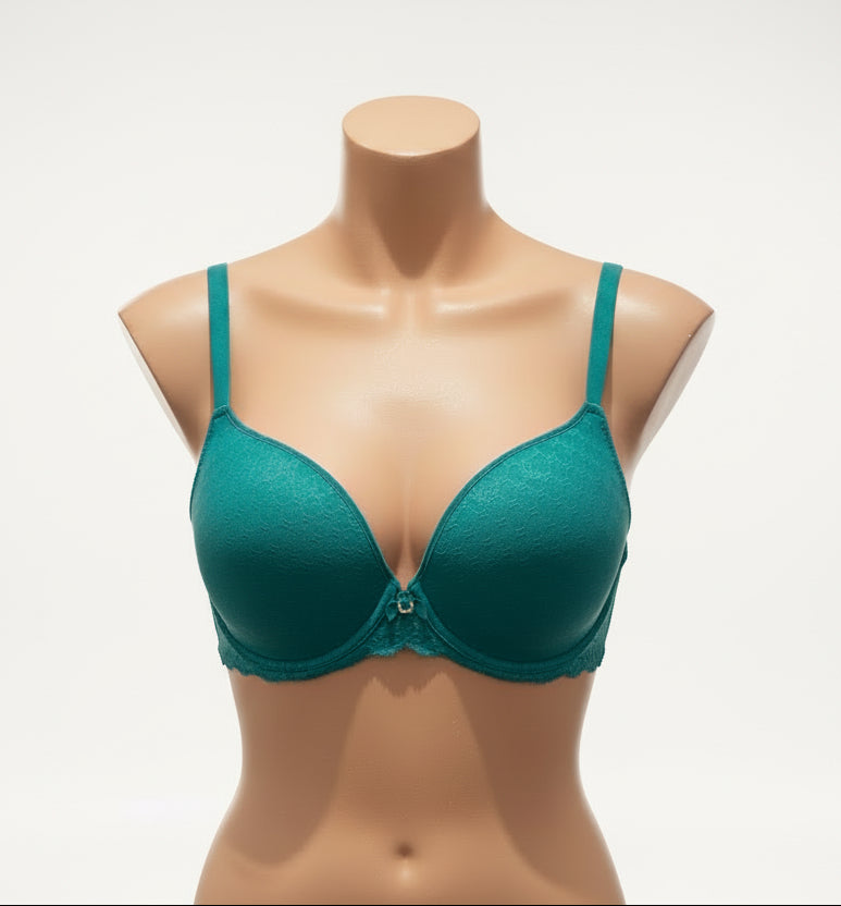 Teal bra on a mannequin against a dark background
