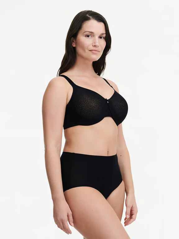 Woman wearing a black bra and high-waisted underwear on a white background