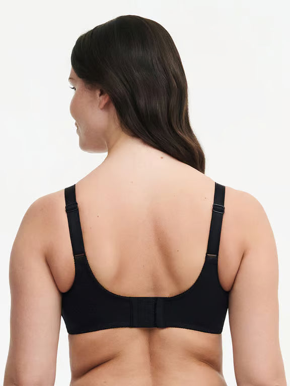 Woman wearing a black bra on a white background