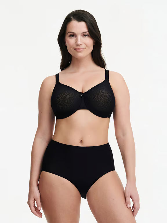 Woman wearing a black bra and panties set on a white background