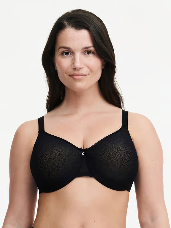 Woman wearing a black bra on a plain background