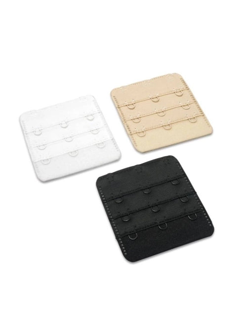 Three bra extenders in white, beige, and black on a white background