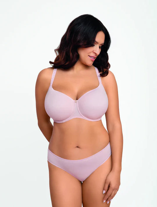 Woman wearing a light pink bra and panties set on a white background
