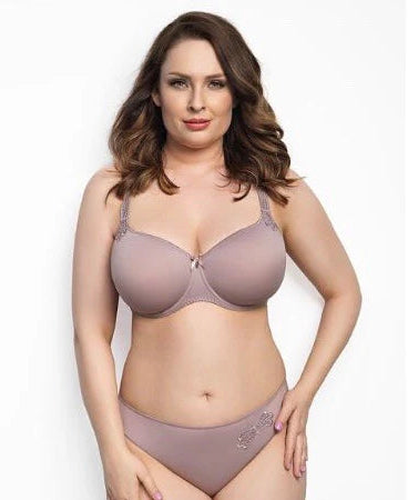 Woman wearing a bra and panties set on a plain background