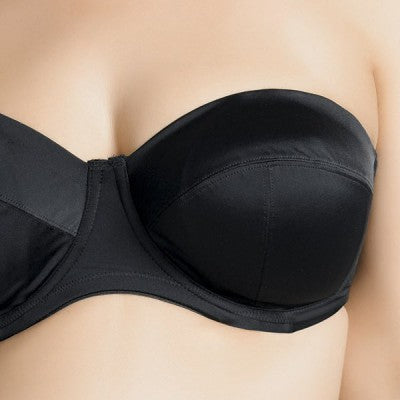 Black strapless bra on a person against a neutral background