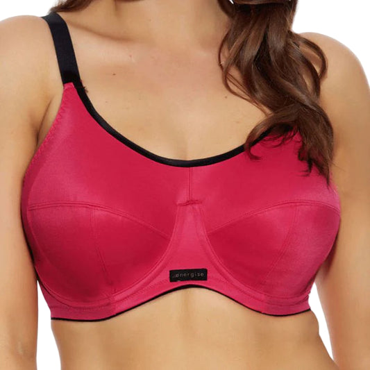 Red sports bra with black trim on a model against a white background