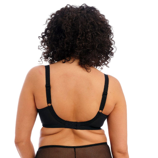 Person wearing a black lingerie set on a white background